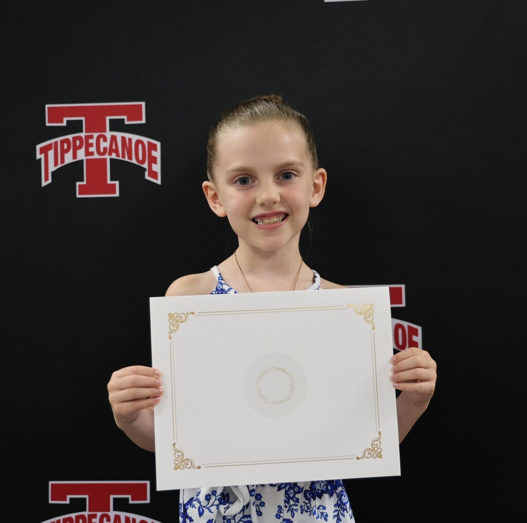 Broadway Elementary student holds her certificate after being honored at the monthly BOE meeeting.