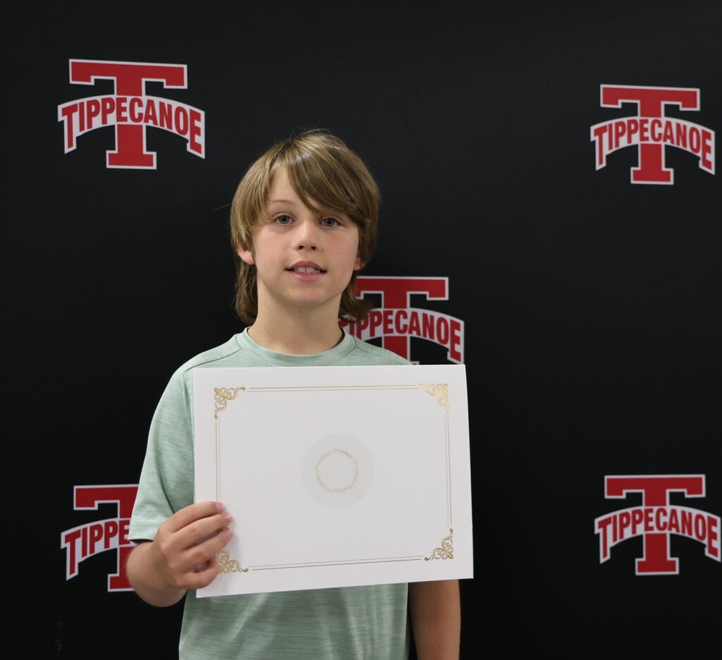 Board of Education honoree holds his certificate for a photo.