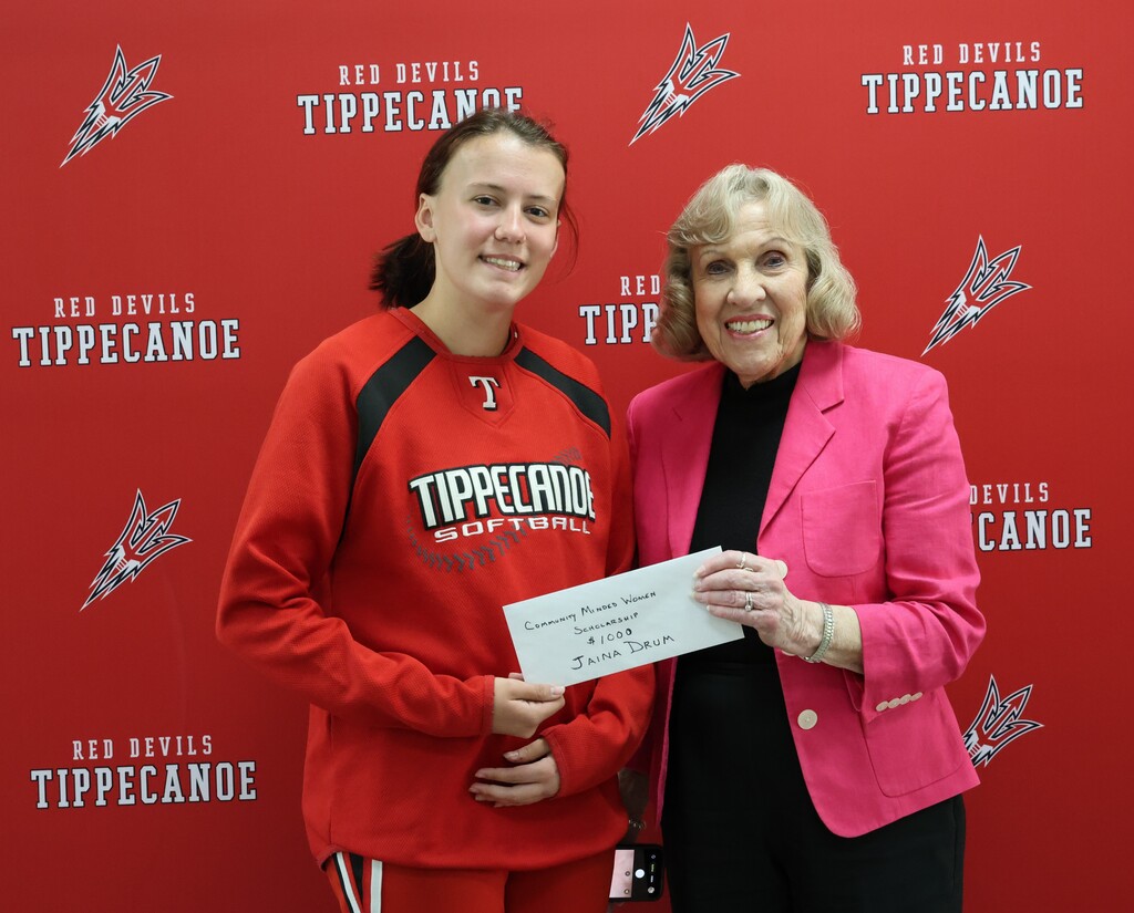Class of 2026 graduate stands with Community Minded Women representative after receiving the CMW  scholarship.