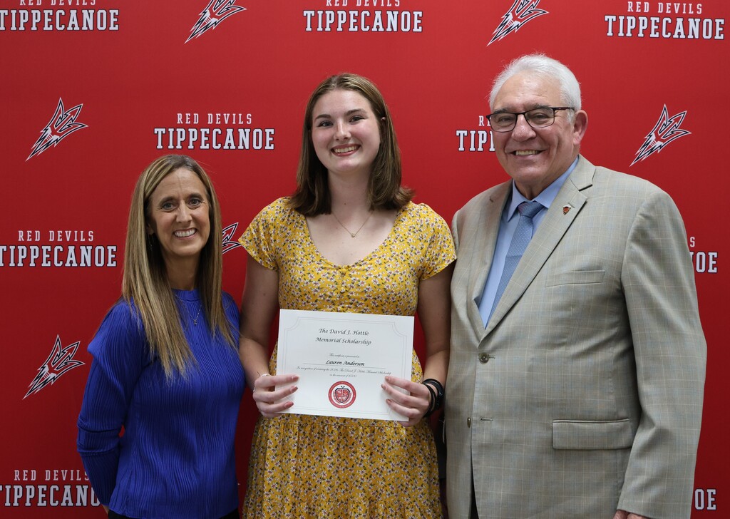 Class of 2026 graduate stands with Hottle family representative after receiving the Hottle Scholarship.