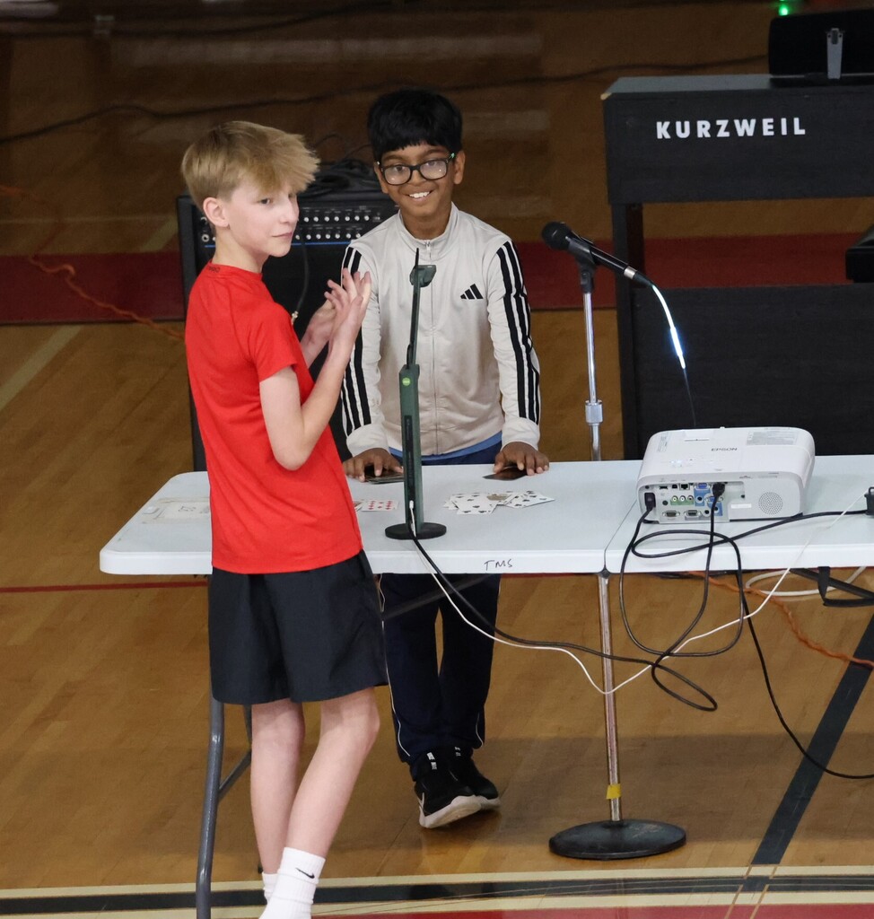 A student does some card magic at the TMS talent show.
