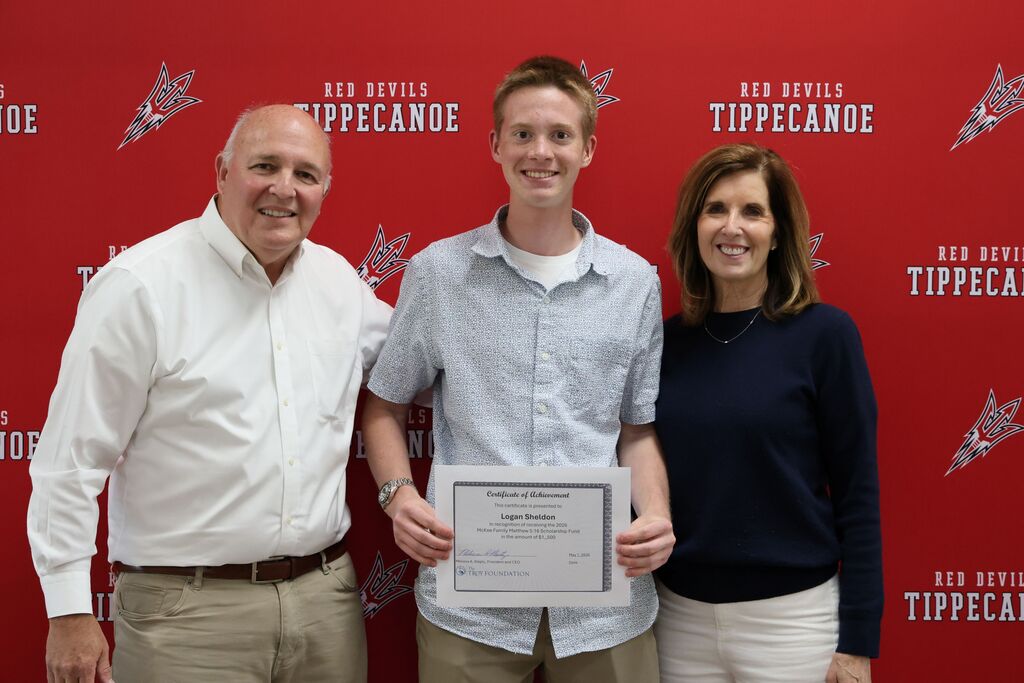 Mr. and Mrs. McKee stand with the recipient of the family's $1,500 scholarship.