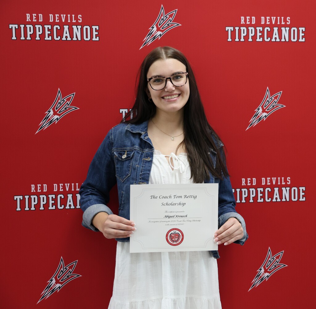 A THS graduate with her certificate after winning a local scholarship.