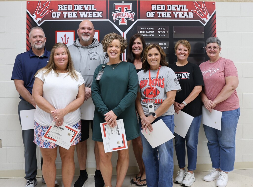 Tipp City Schools staff members stand together after being recognized for 30 years of service in  public education.
