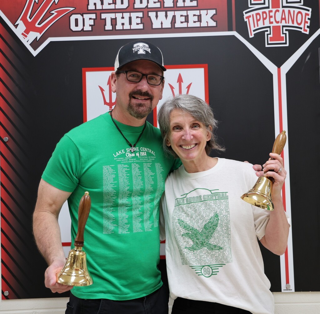 Andy Farrell and Aimee Noel, with their retirement bells and wearing their Lake Shore Central  t-shirts.