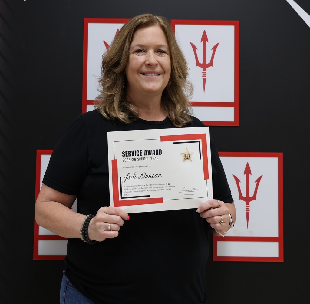 Broadway Elementary Intervention Specialist Jodi Duncan poses with her service award for 35 years in public education.