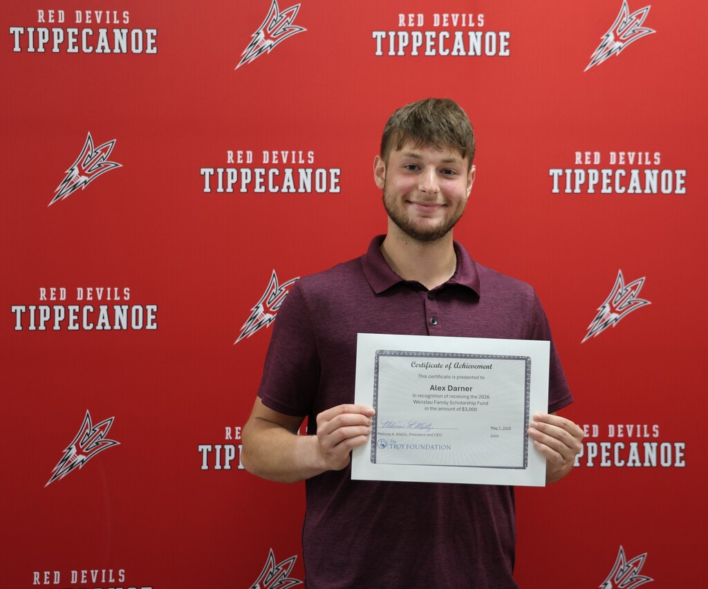 Scholarship recipient Alex Darner holds his certificate.