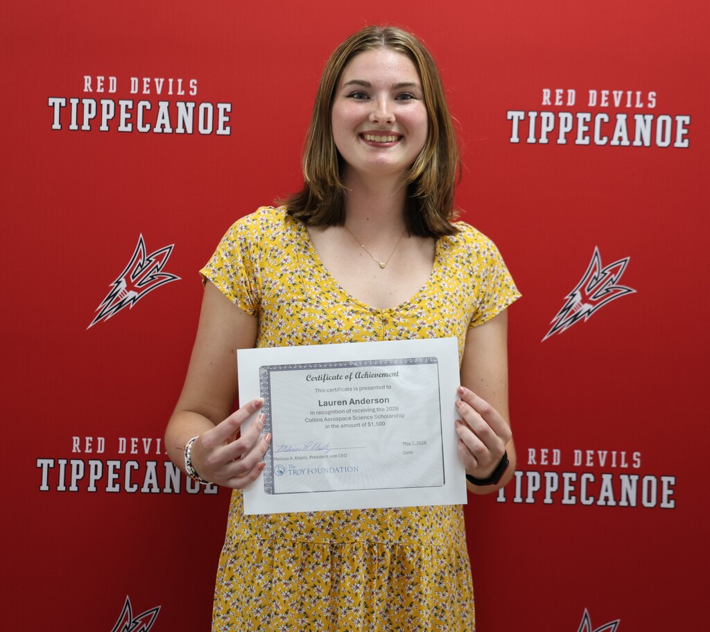 Photo of the Collins Aerospace scholarship with her certificate.  
