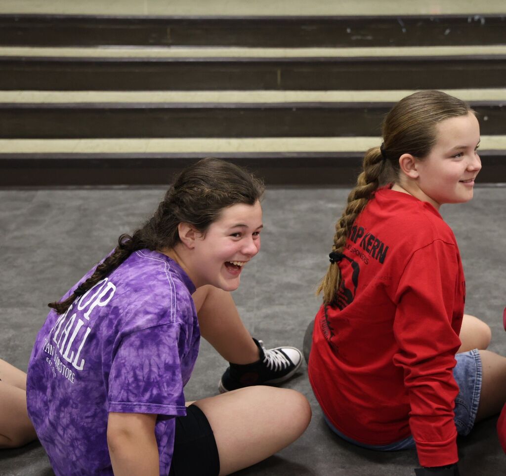 Students react with laughter and smiles as they listen to and learn from a guest speaker.