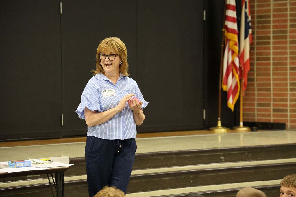 Guest speaker Cathi Hall smiles as she talks with students.