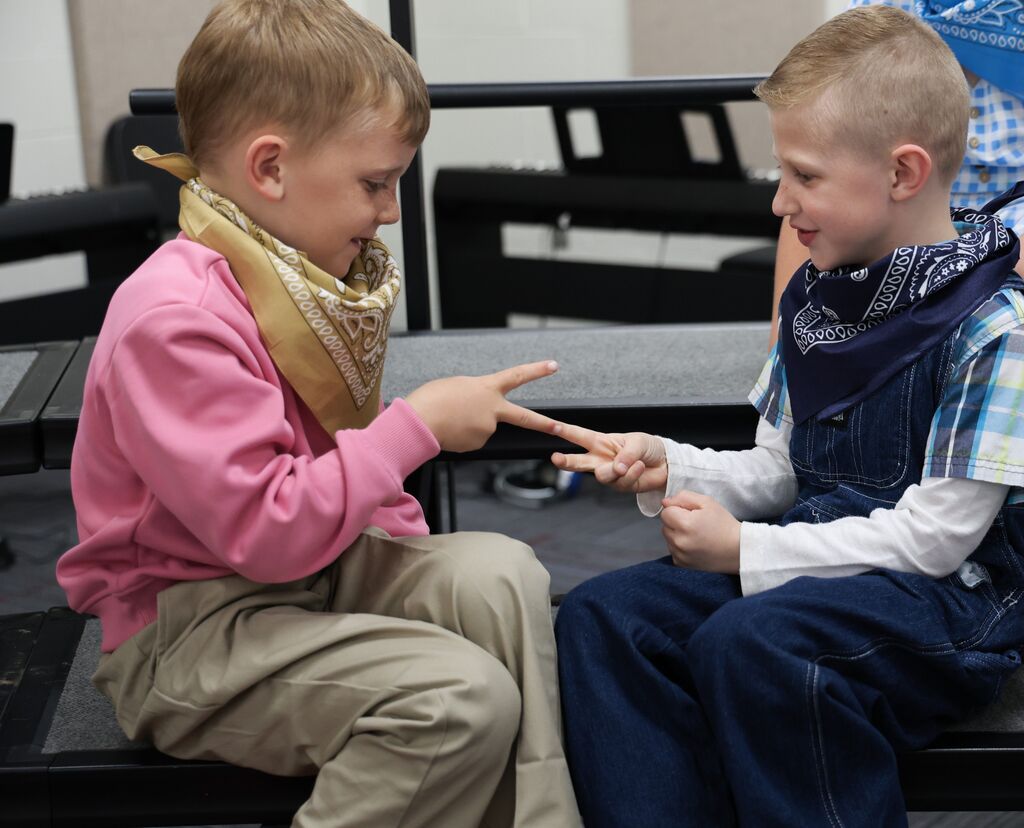 Two boys play rock, paper, scissors. 