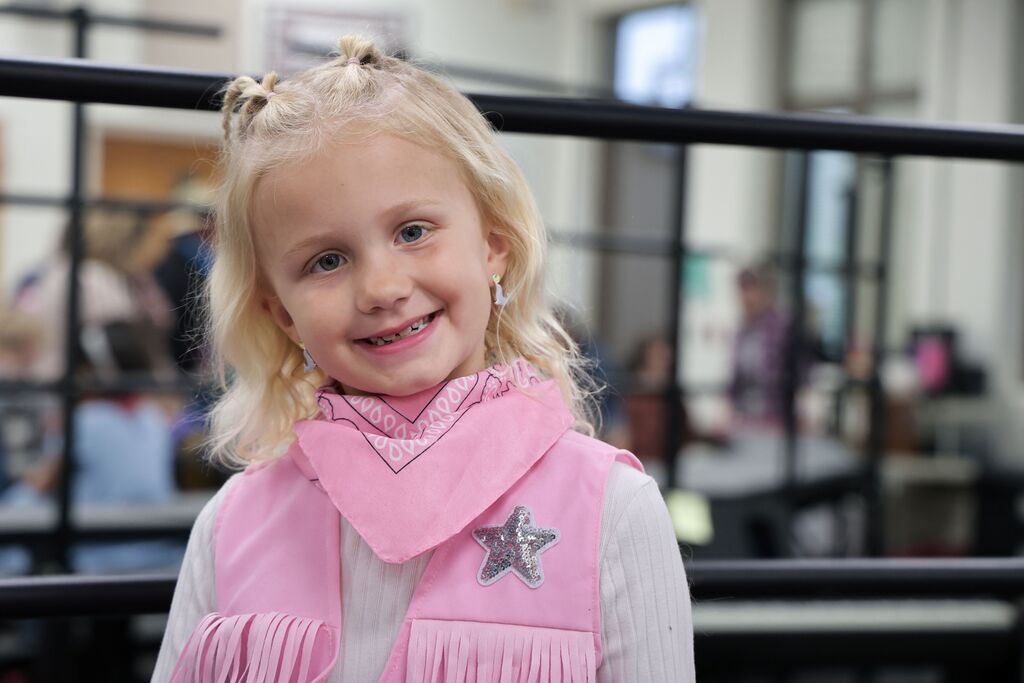A kindergarten student all decked out in pink for the Moosical.