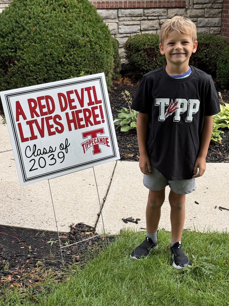 A Red Devil student poses with the new kindergarten Class of 2039 sign.