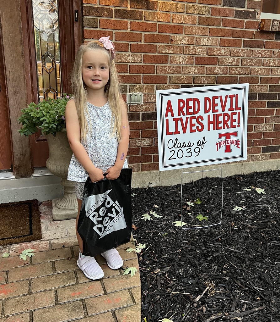 A Red Devil student poses with the new kindergarten Class of 2039 sign.