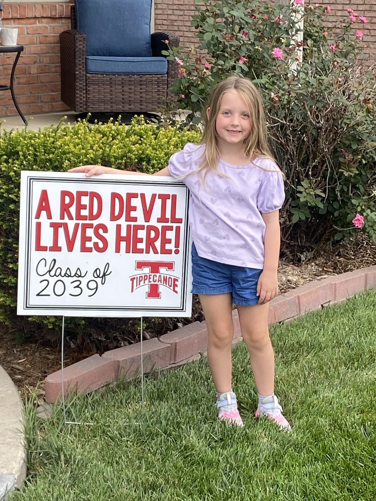 A Red Devil student poses with the new kindergarten Class of 2039 sign.