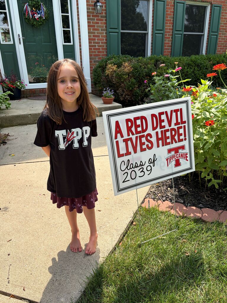 A Red Devil student poses with the new kindergarten Class of 2039 sign.