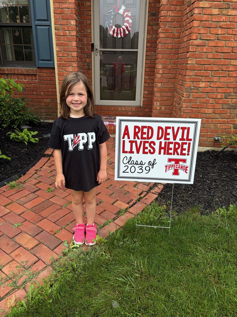 A Red Devil student poses with the new kindergarten Class of 2039 sign.