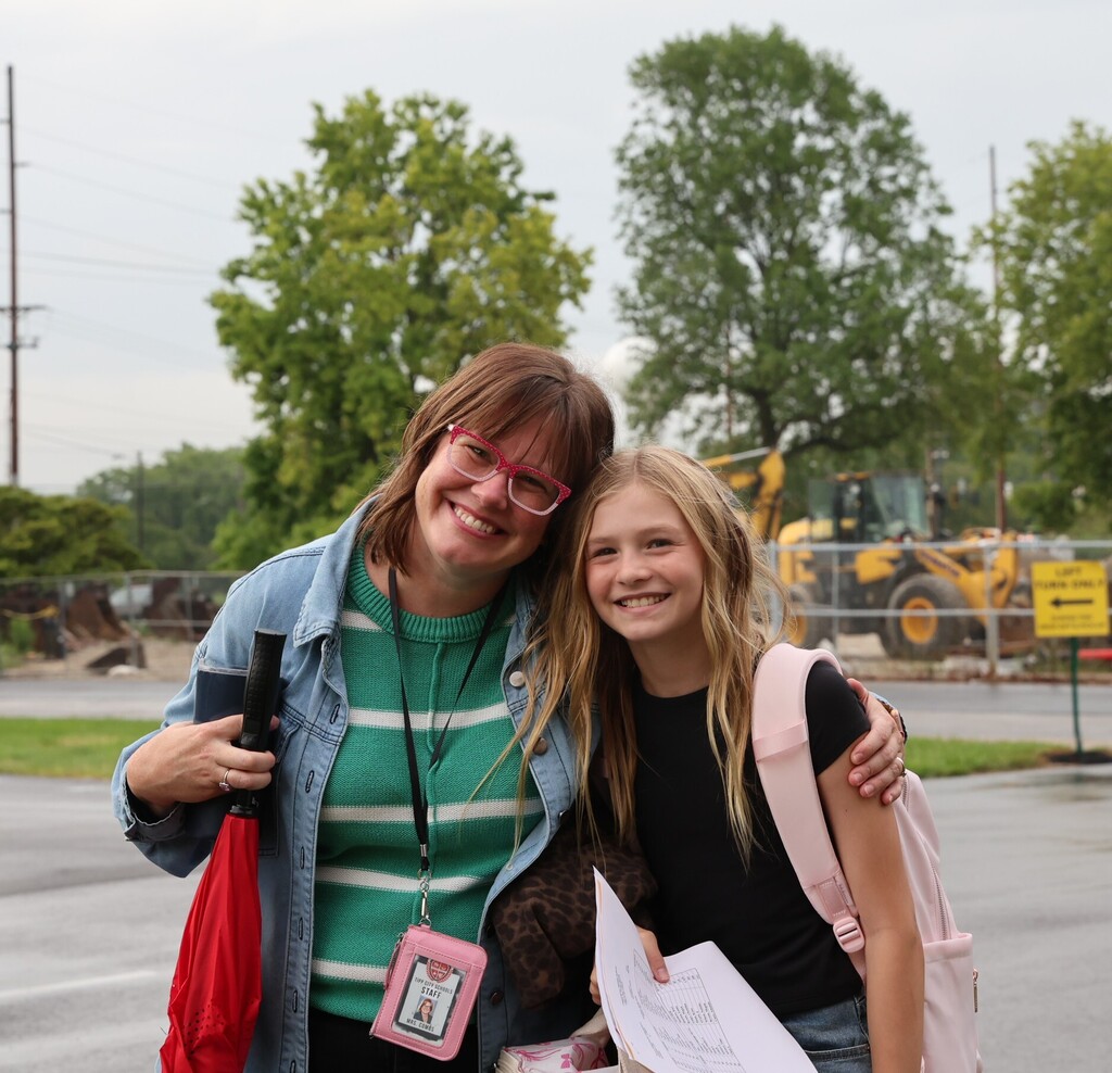 A TMS teacher poses with one of her students. 