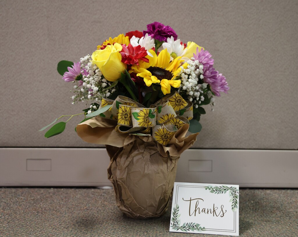 A beautiful vase of flowers and a thank you note.