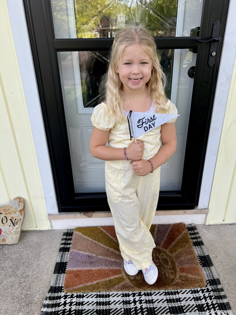 A little girl smiling on her first day of school at Broadway.