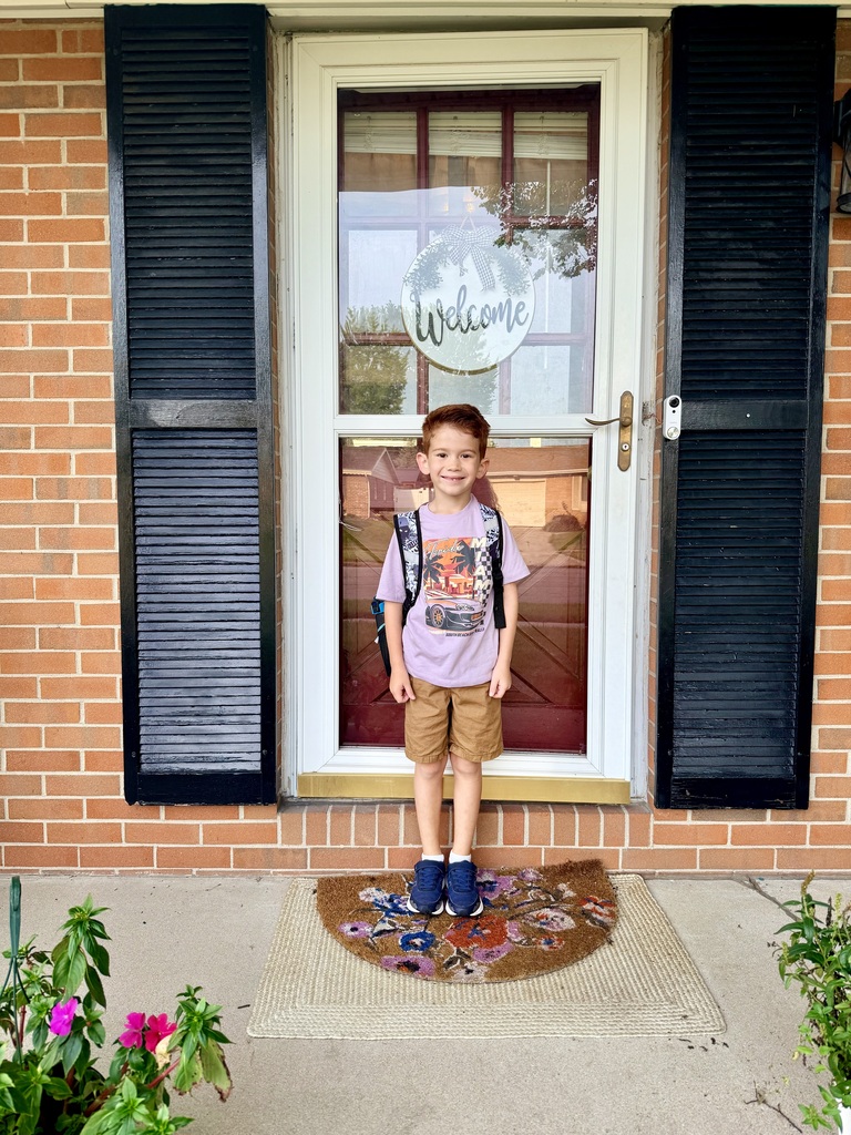 A student poses for his first day of school photo.