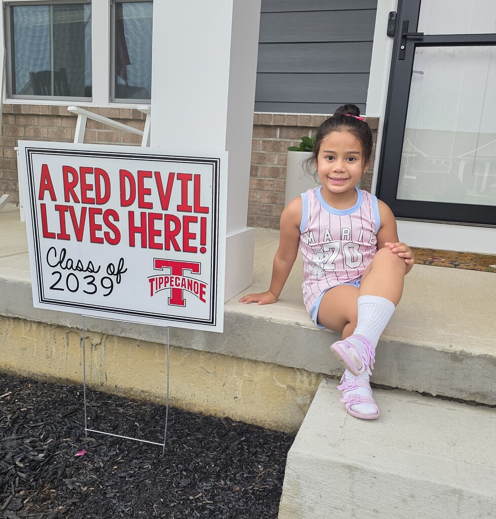 Class of 2039 student poses with her sign.