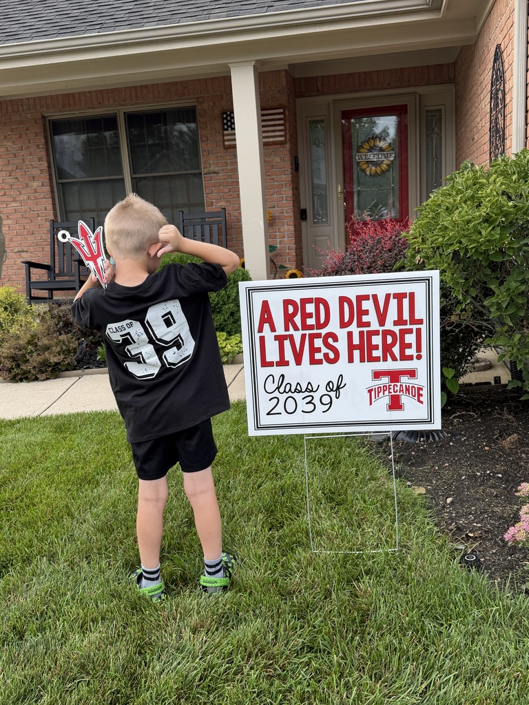 Class of 2039 student next to his sign.