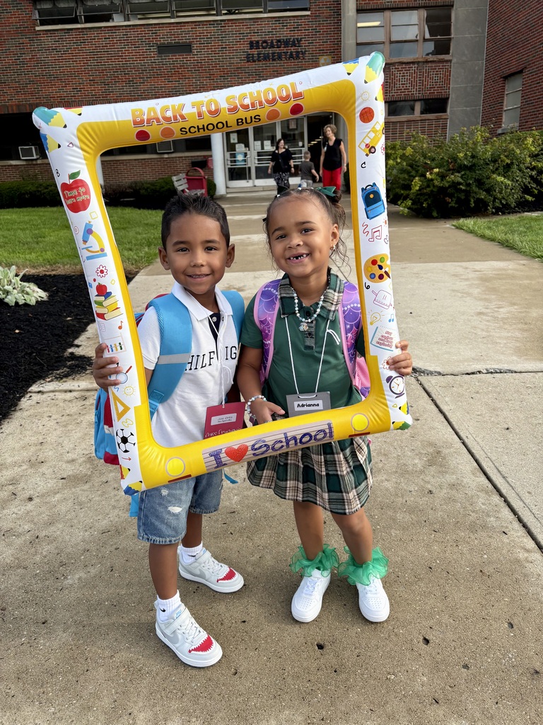 On the first day of school a kindergarten student poses with the Class of 2039 sign.