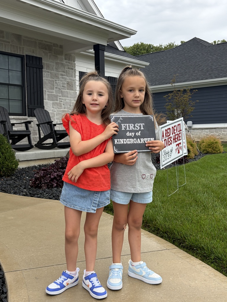 On the first day of school kindergarten students pose for a photo.