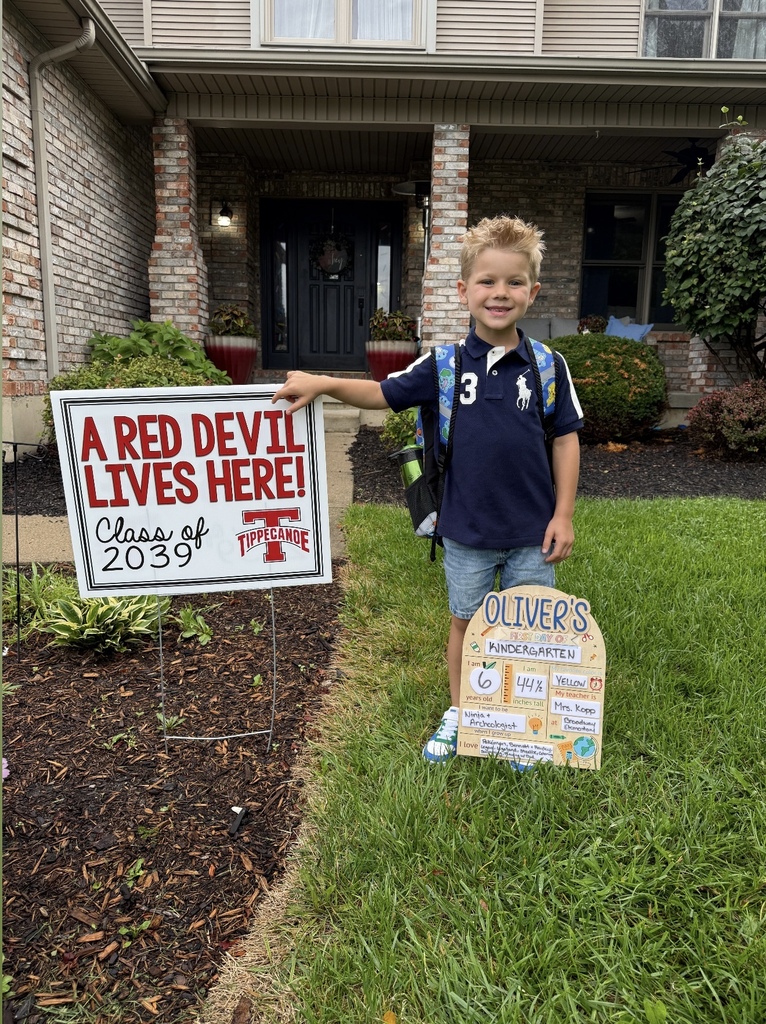A first day kindergarten picture with one of our students and the Class of 2039 yard sign.