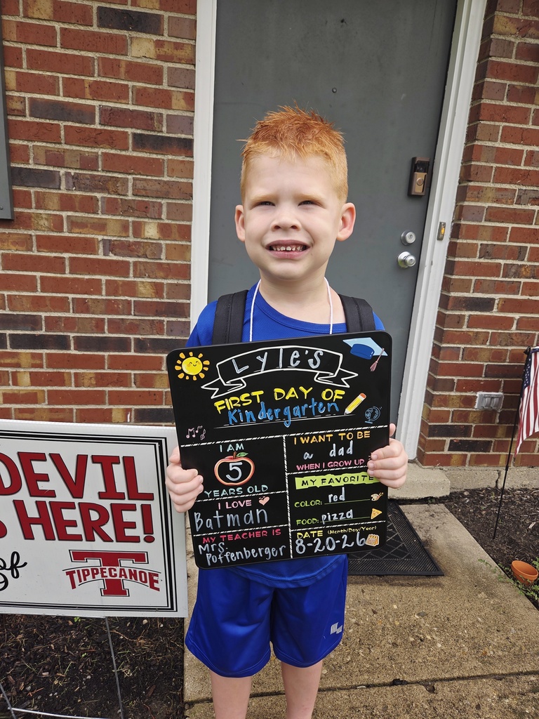 A first day kindergarten picture with one of our students and the Class of 2039 yard sign.