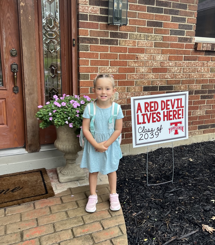 A first day kindergarten picture with one of our students and the Class of 2039 yard sign.