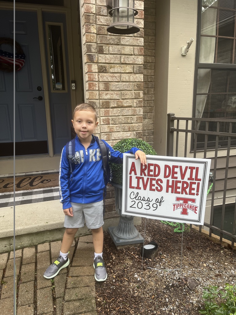 A first day kindergarten picture with one of our students and the Class of 2039 yard sign.