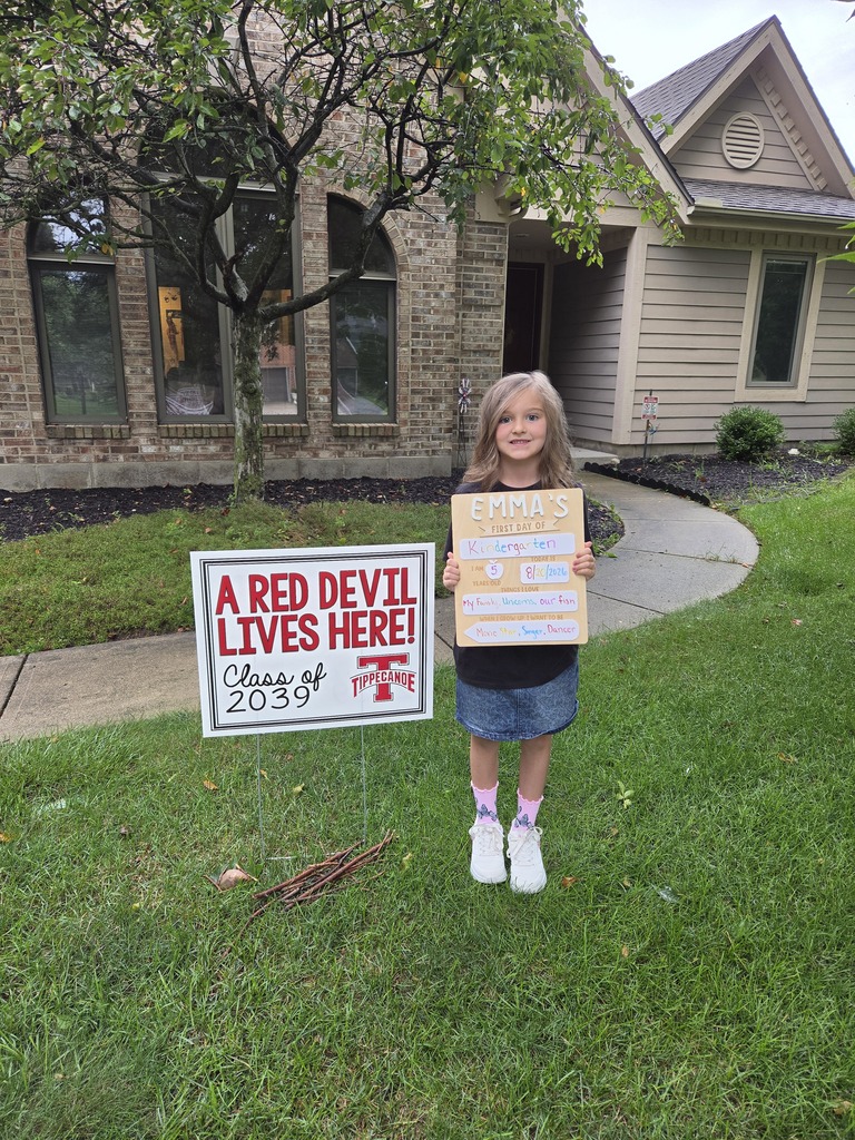 A first day kindergarten picture with one of our students and the Class of 2039 yard sign.
