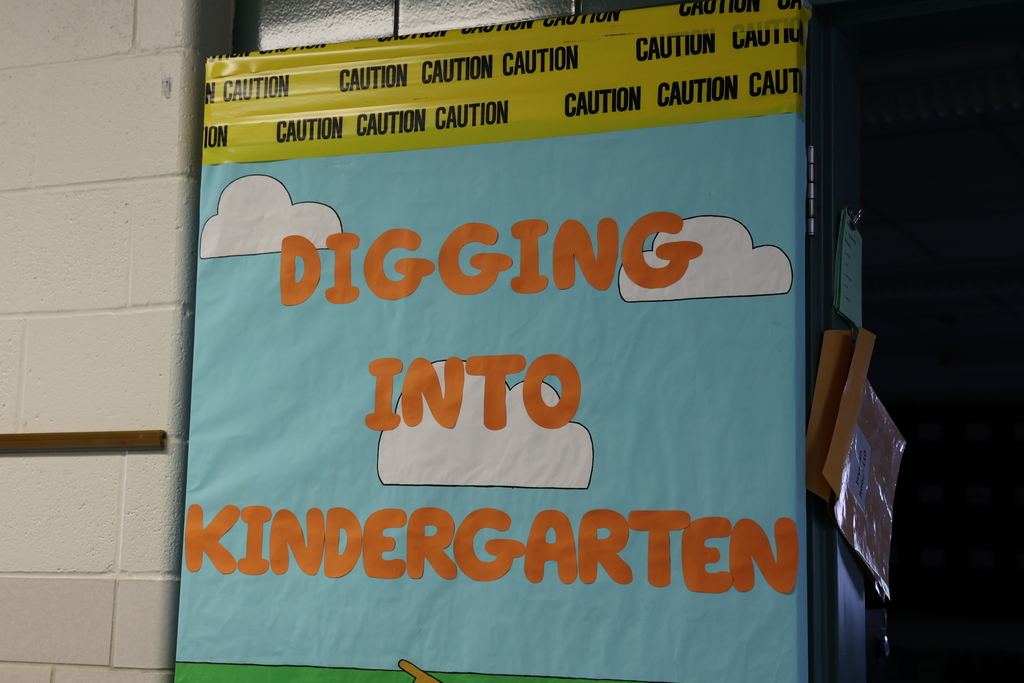 A classroom door that says digging into kindergarten.