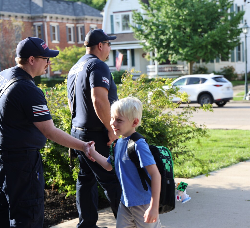 Tipp City Fire, EMS, and Police greet students on the first day of school with fist bumps, hi fives, smiles, and encouragement. 