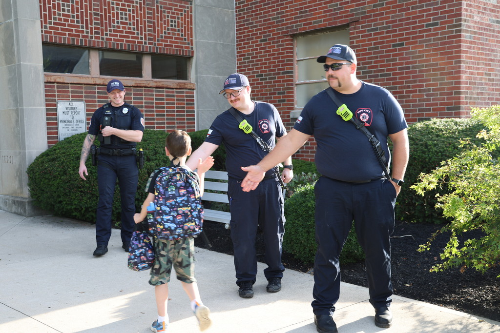 Tipp City Fire, EMS, and Police greet students on the first day of school with fist bumps, hi fives, smiles, and encouragement. 
