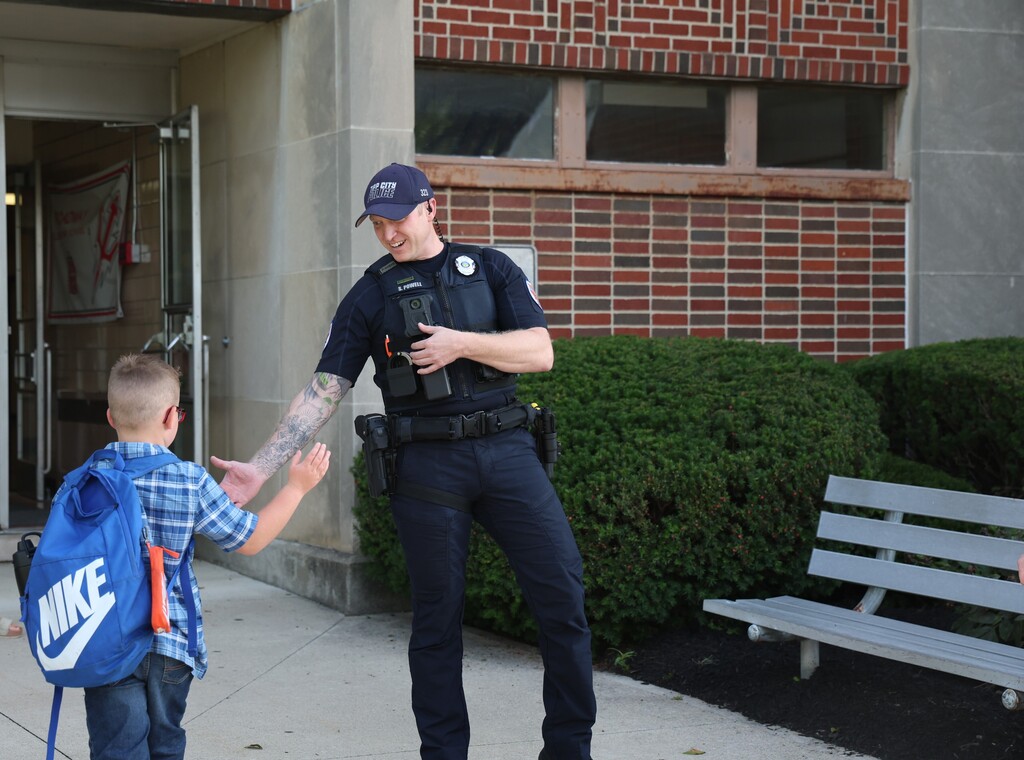 Tipp City Fire, EMS, and Police greet students on the first day of school with fist bumps, hi fives, smiles, and encouragement. 