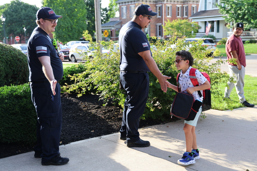 Tipp City Fire, EMS, and Police greet students on the first day of school with fist bumps, hi fives, smiles, and encouragement. 