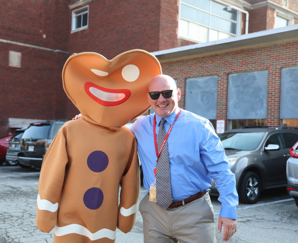 District superintendent poses with the Gingerbread man.