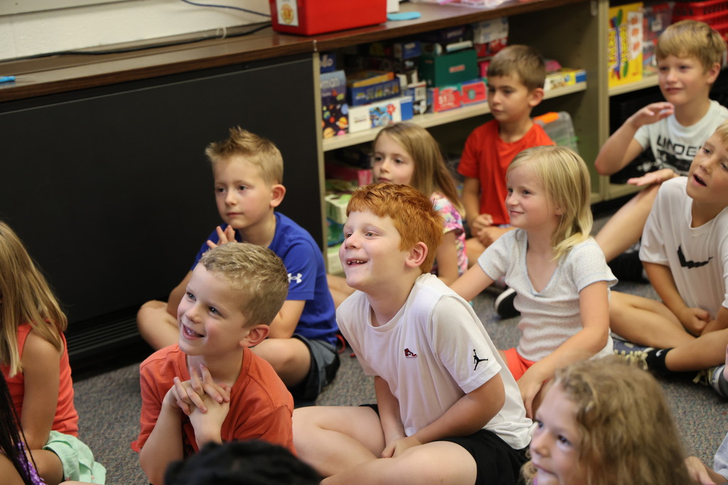 First graders at Broadway react to the story being read to them during story time.
