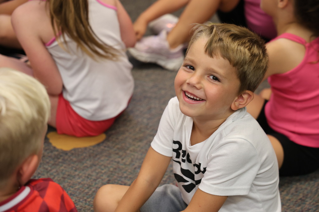 A very cute boy with a picture smile looks right at the camera.