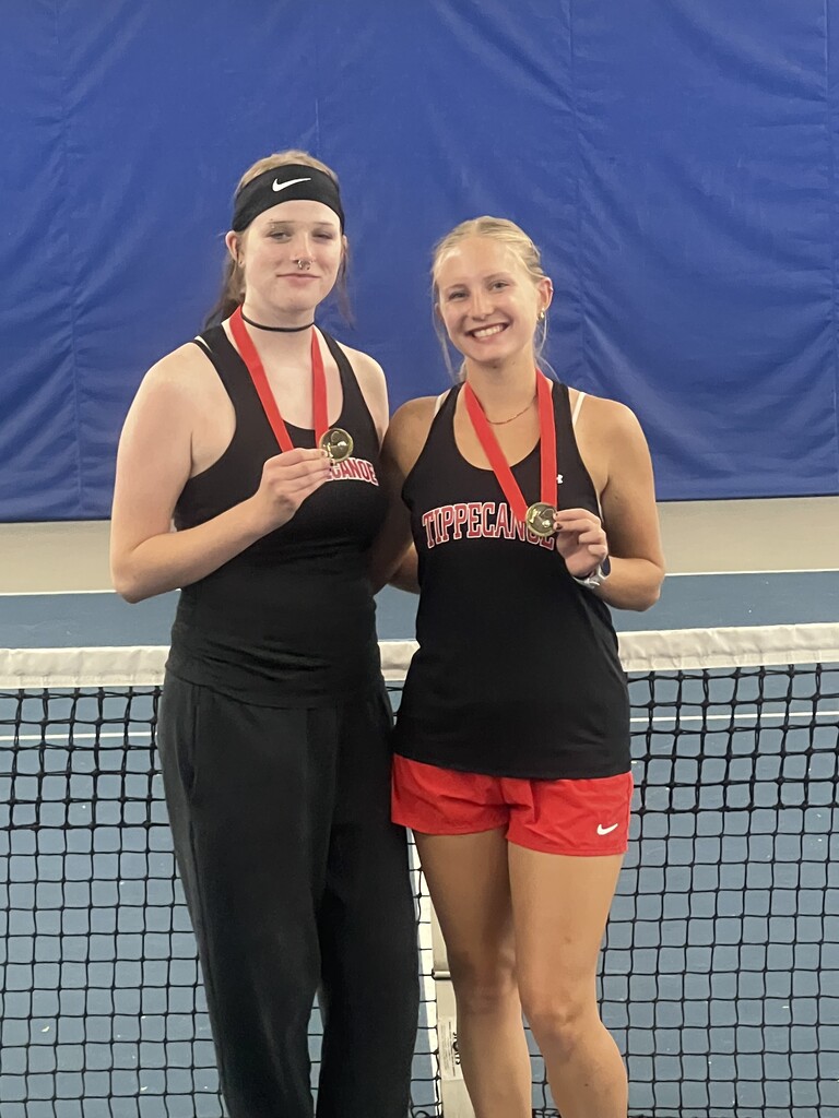 Tippecanoe High School Athletes of the Week hold their medals after a recent tennis match win.