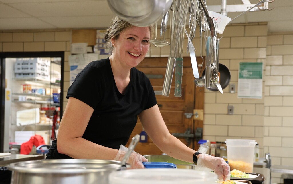 A Broadway Elementary kitchen staff member preps salads for lunch.