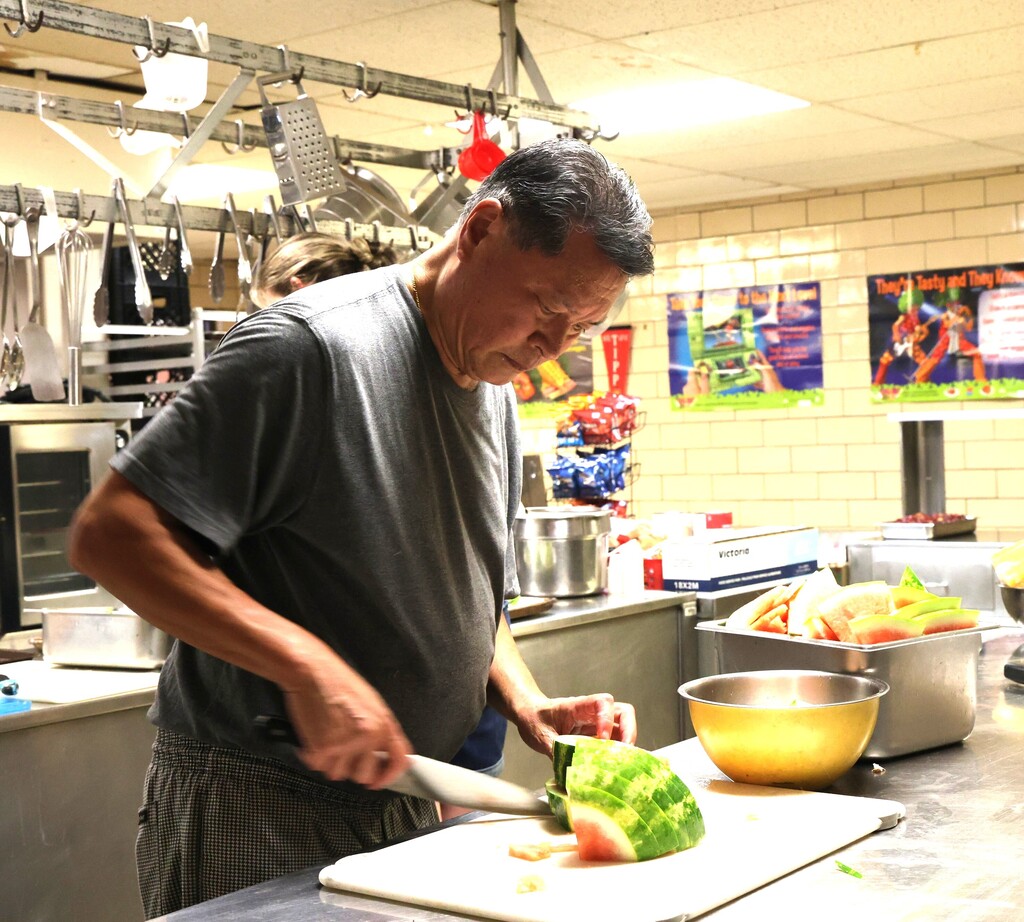 Chef Art Chin at Broadway slices watermelon for lunch.