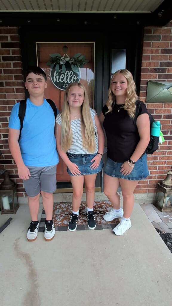 Three students on their first day of school for the new year.