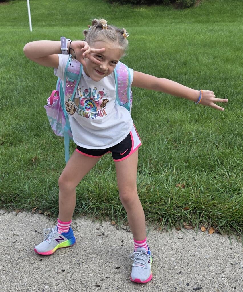 A students makes an enthusiastic expression on the first day of a new school year.
