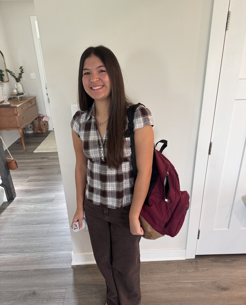 A student is all smiles for the first day of school.