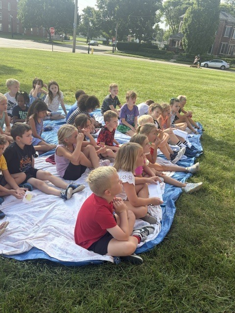 Students listen to a story.