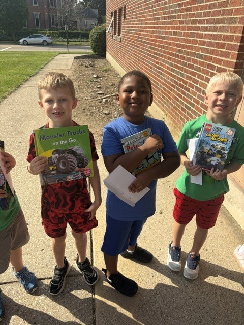 students hold their books from the Book Bike.
